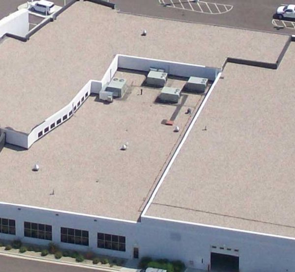 A large building with many air conditioning units on the roof.